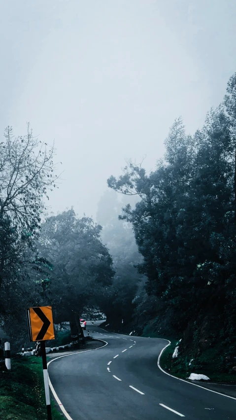 an empty road is on a foggy day