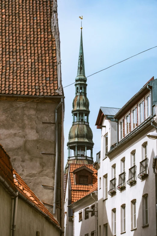 view from below looking down at buildings and clock tower