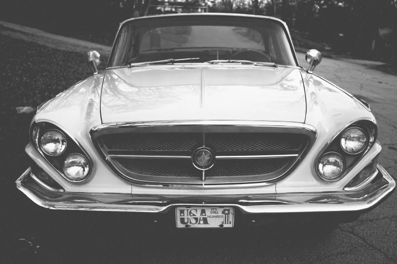 a white mercedes benz coupe parked on the road