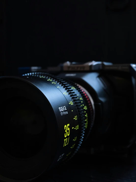 a camera lens on a table with a dark background