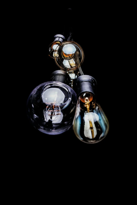 three light bulbs turned to resemble blown glass