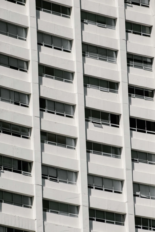 a grey building with balconies against the sky