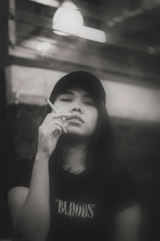 a woman smoking a cigarette in a dark room