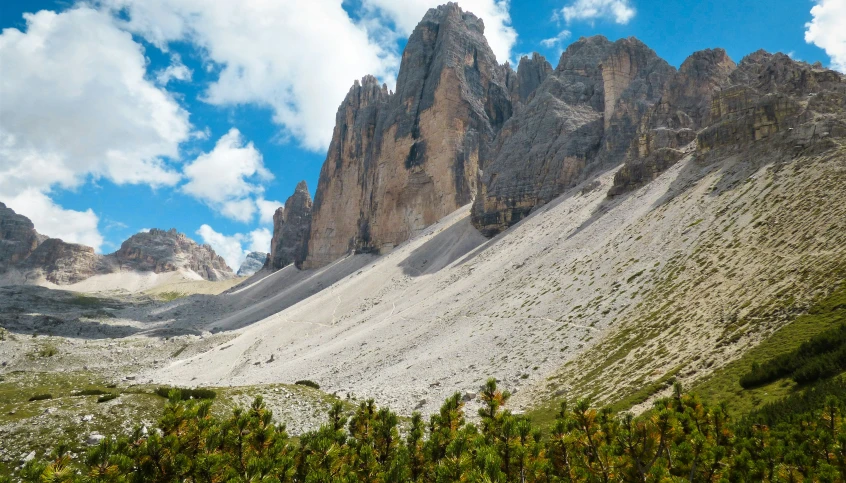 a group of rocks sticking up from a green valley