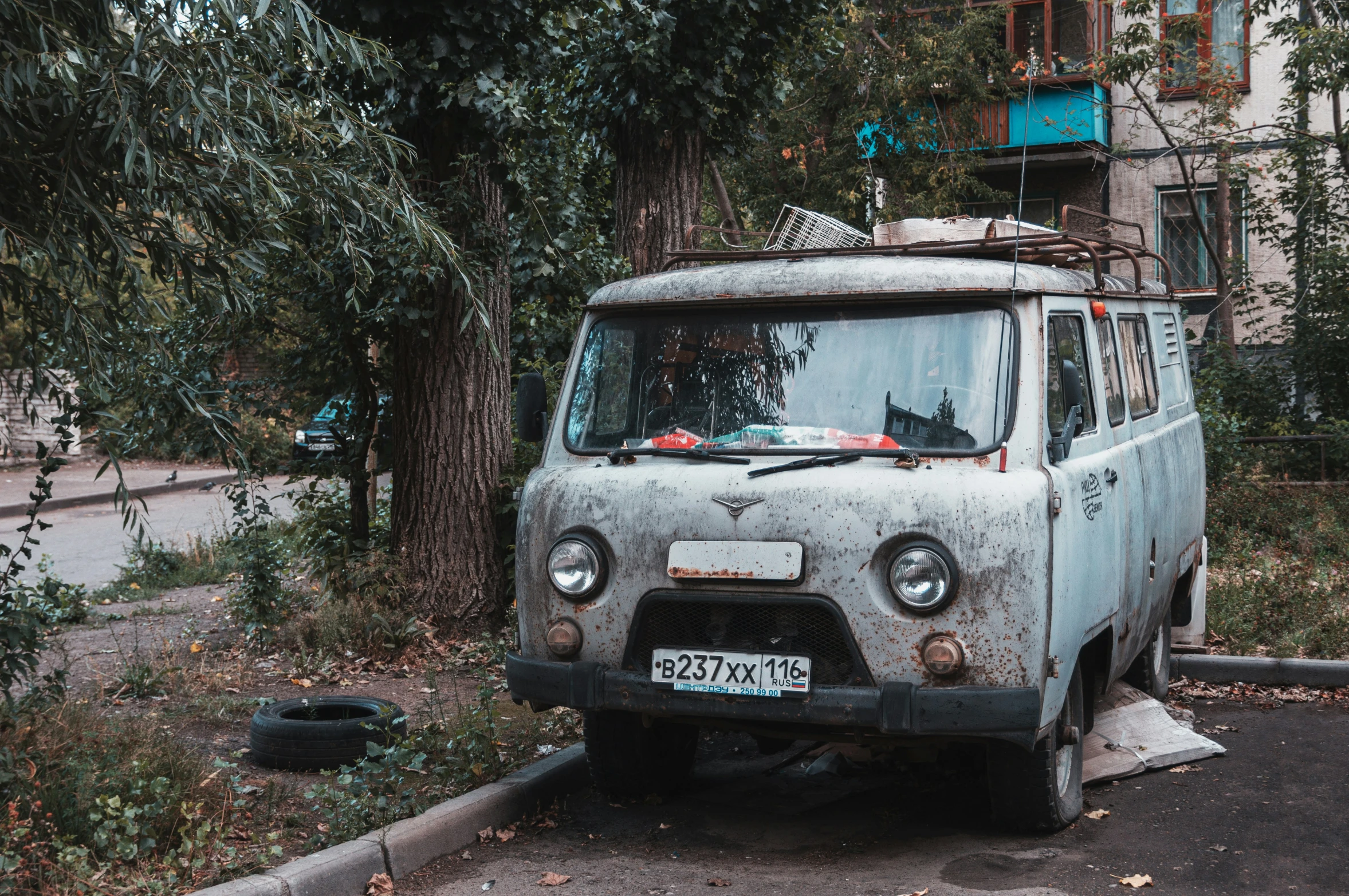 a van parked in the street, covered with nches