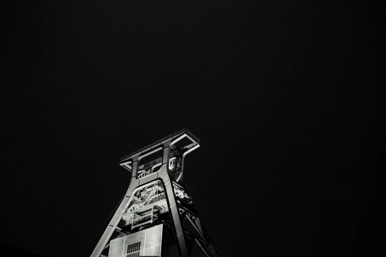 a black and white po of a tower that has a clock