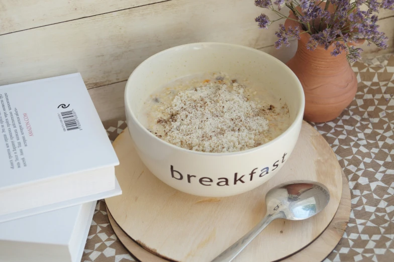 a bowl filled with food sitting on top of a table next to a pile of paper