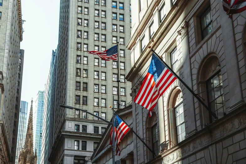 two flags in front of the rockefeller building