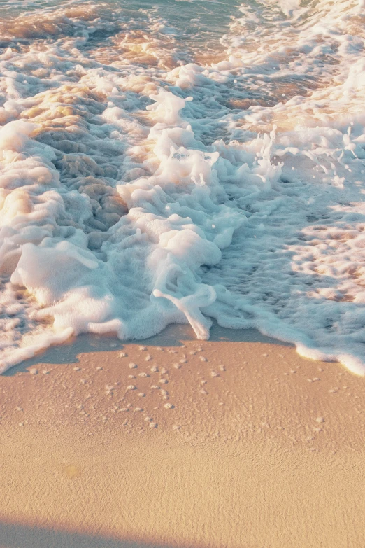 the beach is covered with waves and sea foam