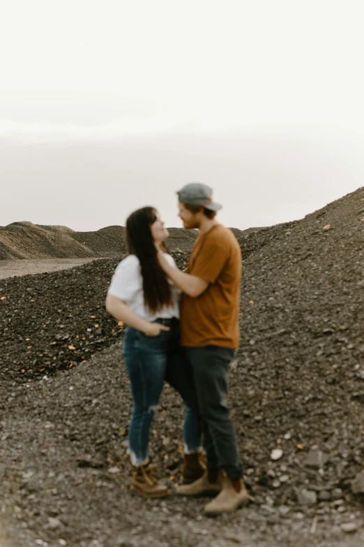 two people on a mountain and one person holding the other