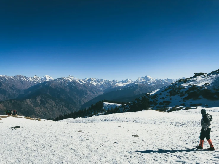 a man standing on top of a snow covered slope