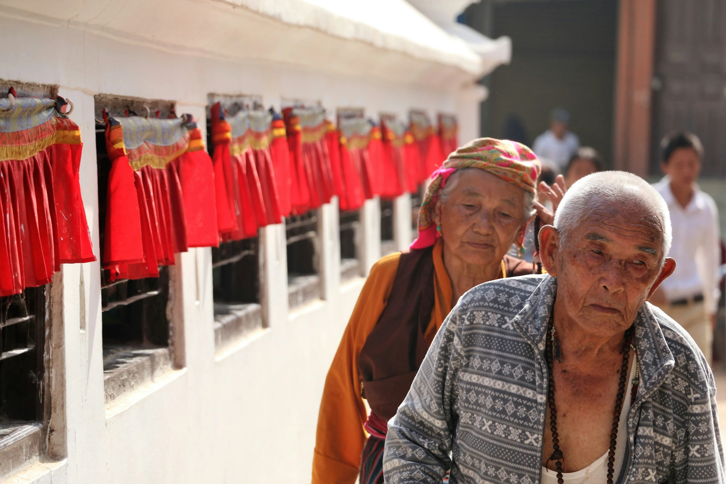 some elderly people are walking together in line