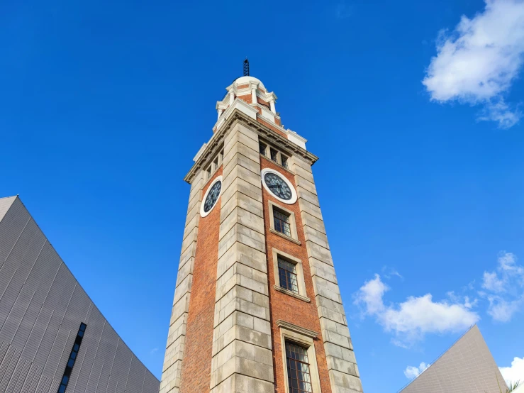 a very tall brick building has a clock on it