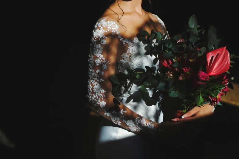 a woman holding a bouquet of flowers at the end of the night