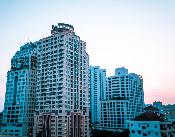 a very tall white building near the water