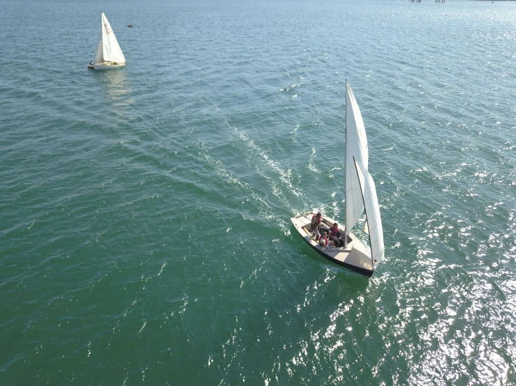 two sailboats out on a body of water