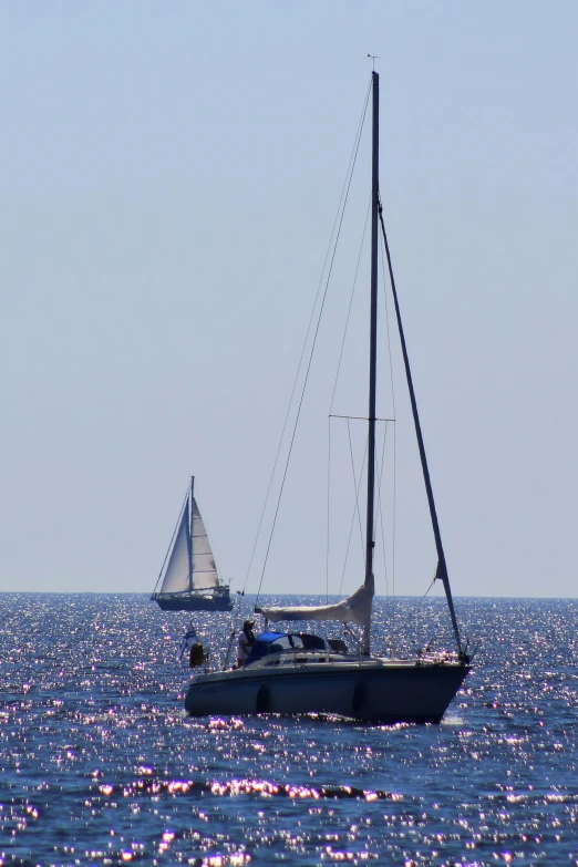 the sailboat is sailing in the ocean alone