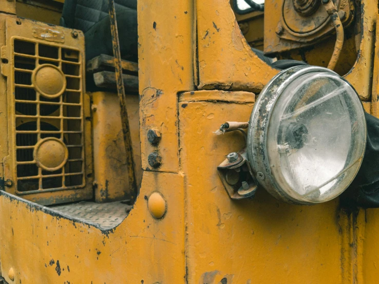 an old yellow industrial truck door with a headlight