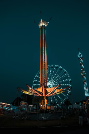 a ferris wheel in the dark with people on the side