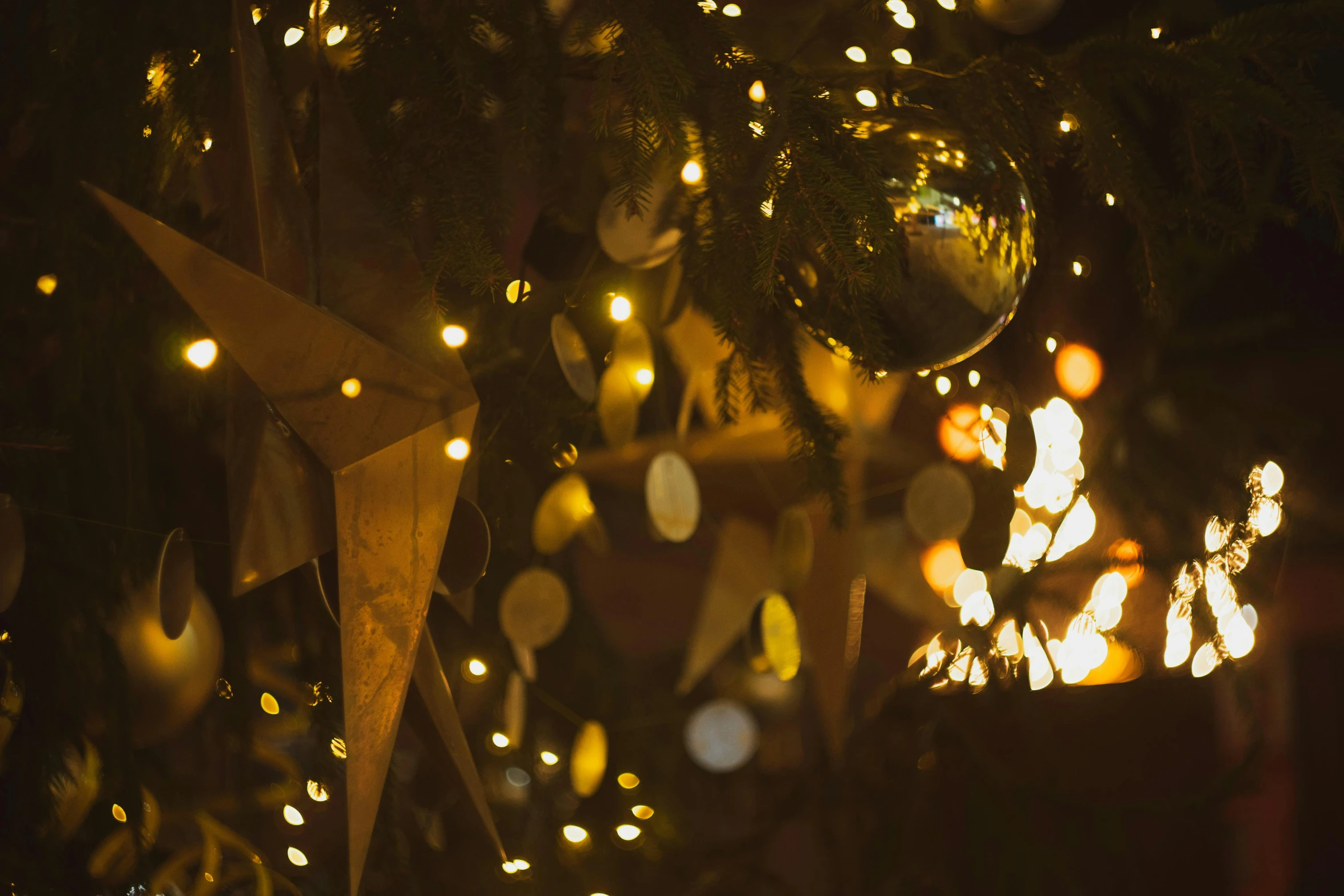 an upclose po of a christmas tree with balls on it