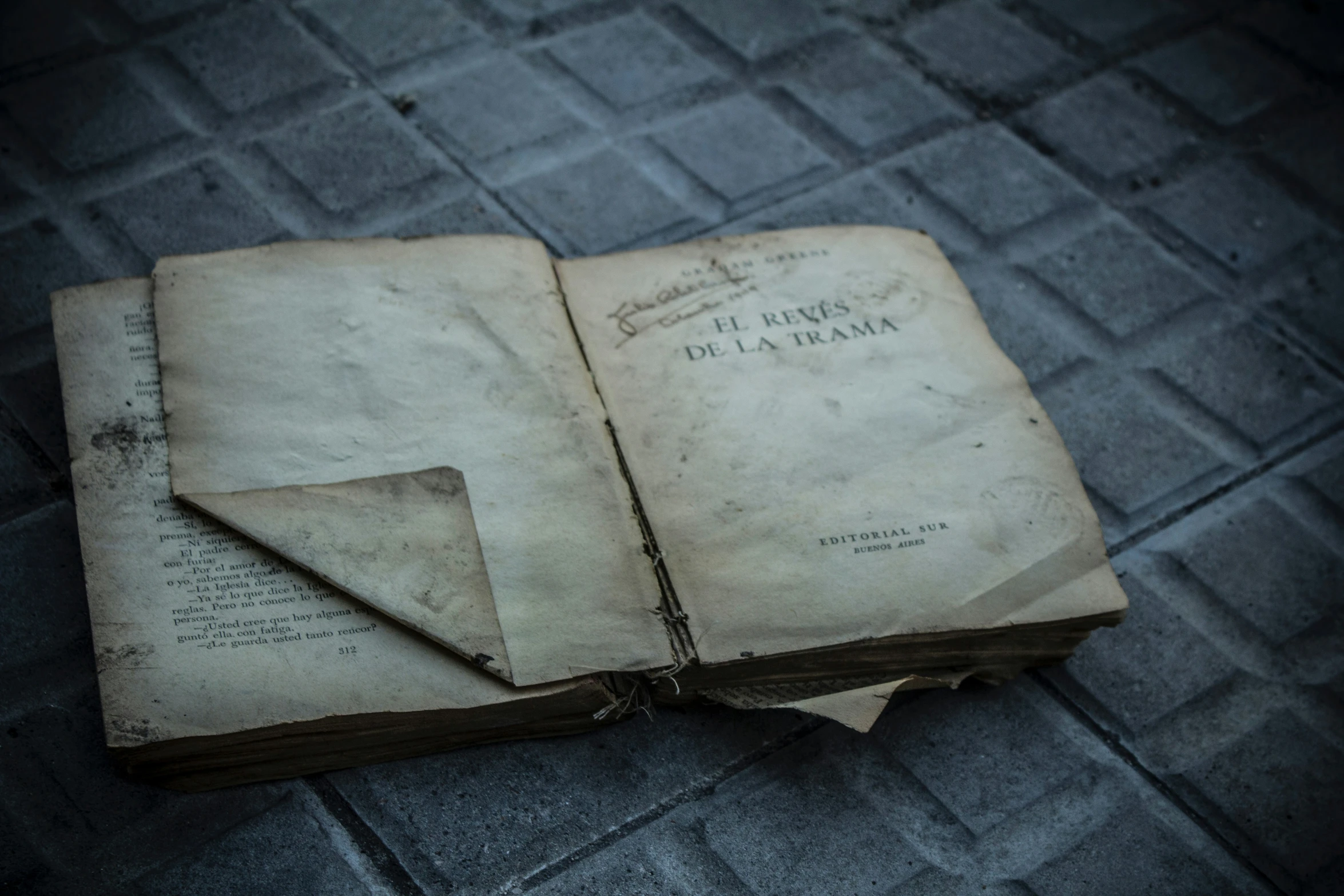 old books on concrete floor with brick patterning