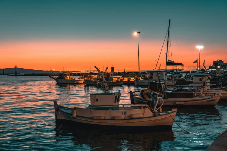 a fleet of small boats are parked at the end of the water