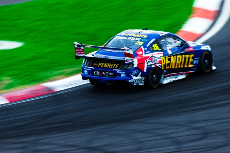 a blue sports car driving on the track