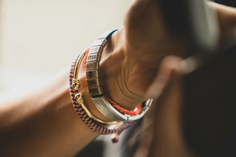 woman with two celets showing each other