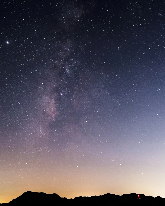 the night sky and stars above mountains