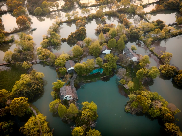 an aerial view of a river in a residential neighborhood