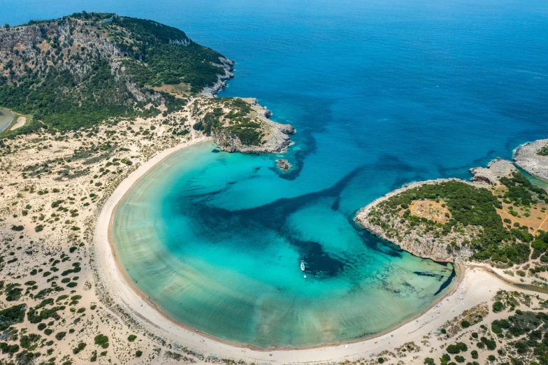 an aerial po of boats anchored in a shallow lagoon