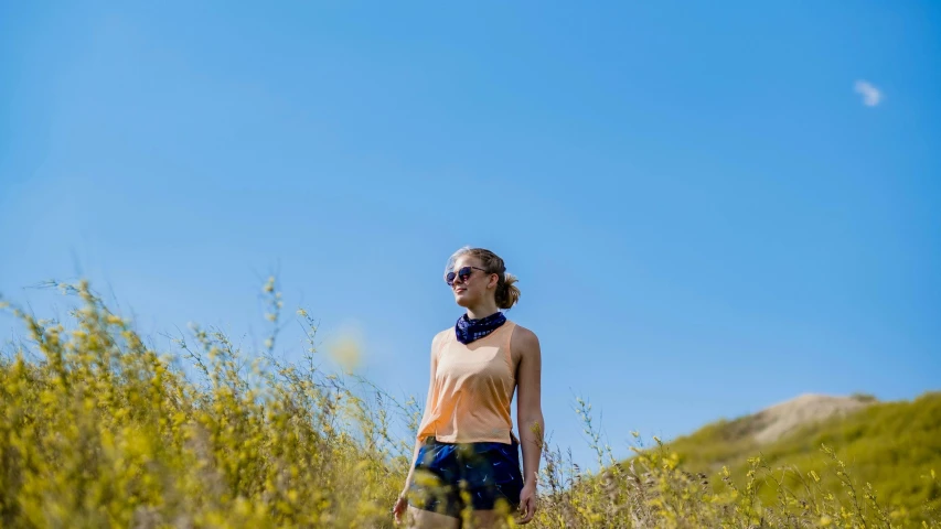 a girl in some blue shorts and an orange shirt