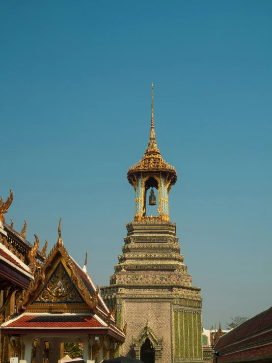 an ornate tower stands against the blue sky