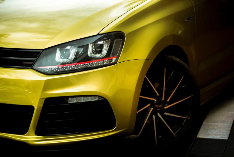 this is the front end of a yellow volkswagen