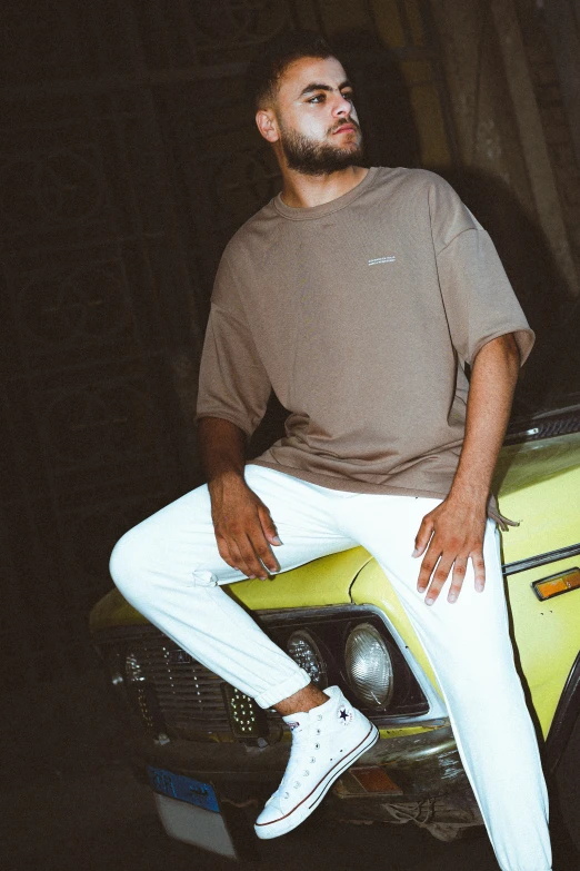 a man sitting on top of a yellow car