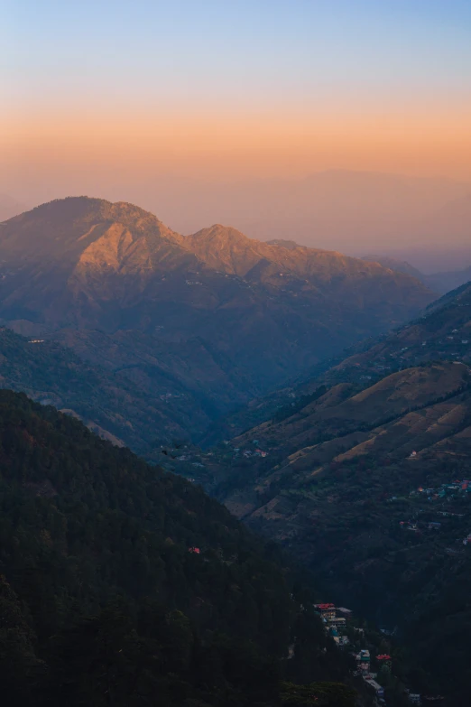 a beautiful view over mountains from top of a hill