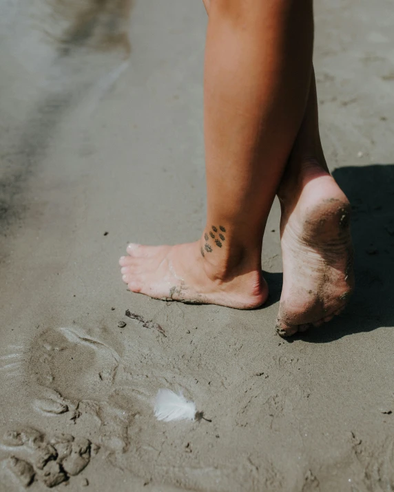 a person standing on sand near the beach