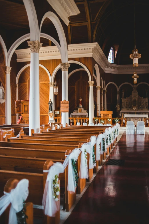 the church has a row of pews set up for a wedding