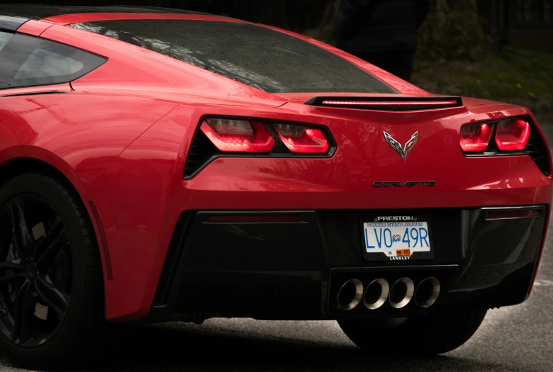 close up view of the tail light of a red sports car