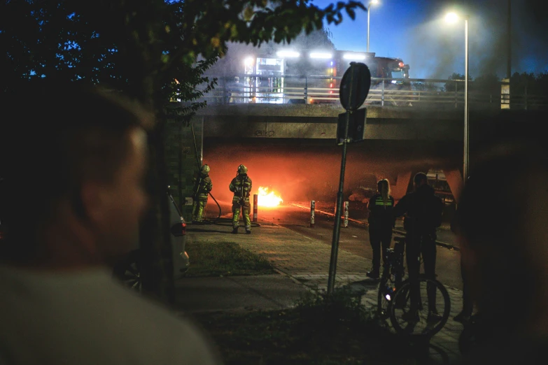 a couple of people that are standing by a bike