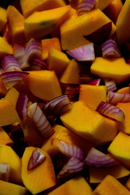 a plate filled with sliced yellow and red vegetables