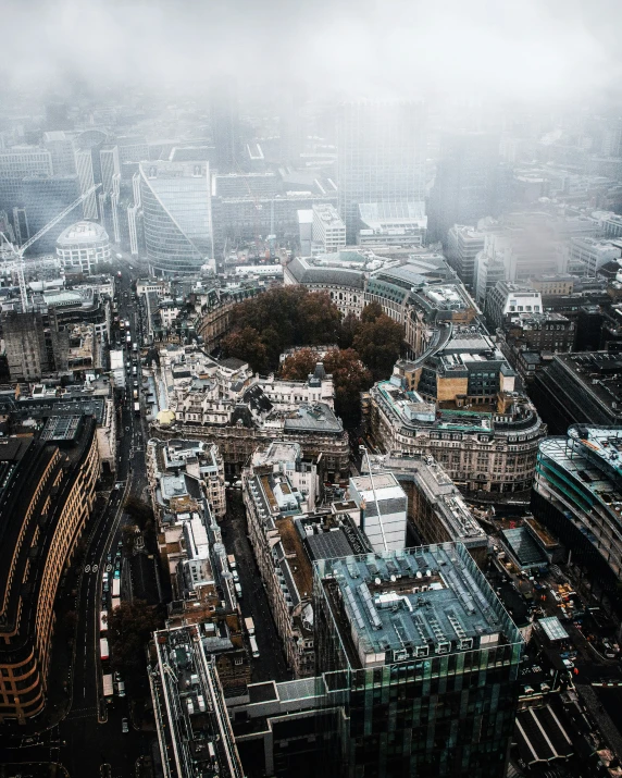 the city is in heavy fog with some buildings