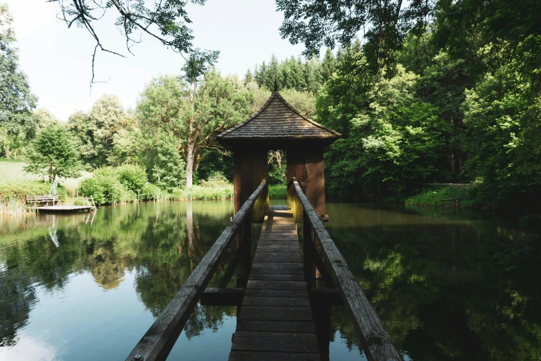 a wooden structure is in the middle of a lake