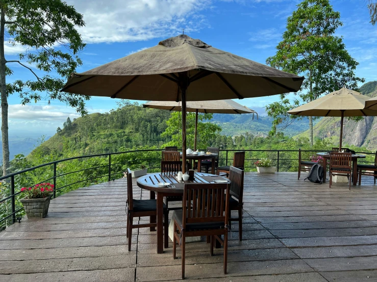 tables and chairs on top of a large stone patio