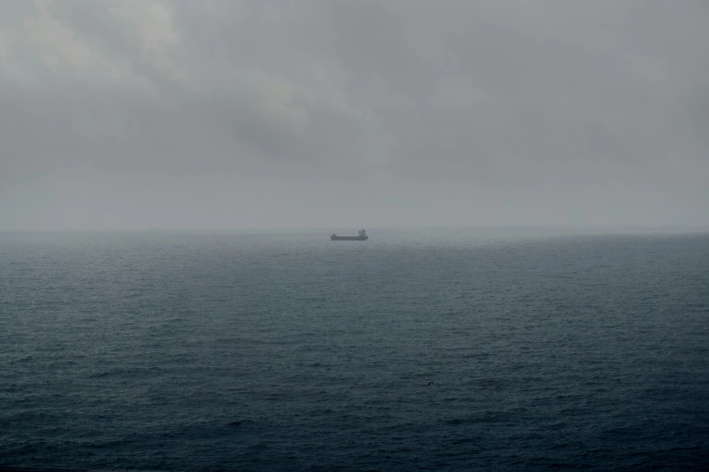 boat in a large body of water on a gray day