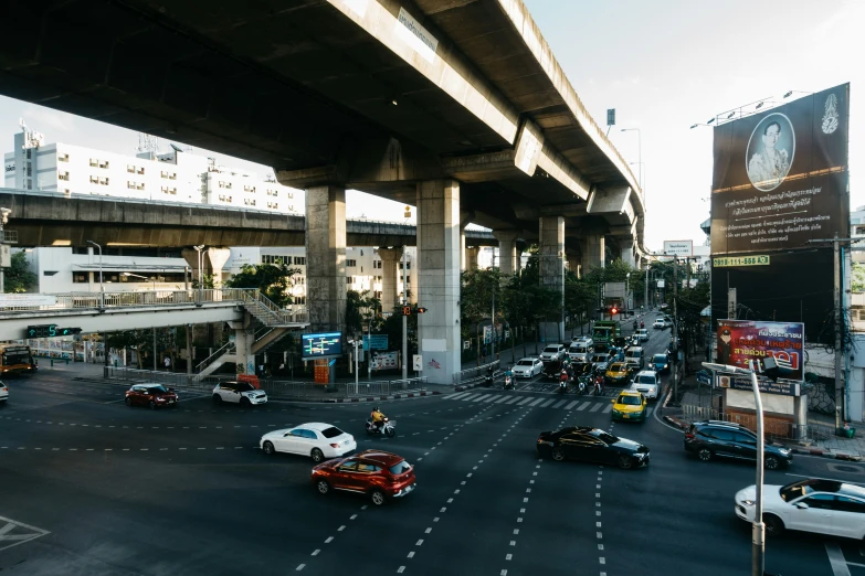 a street filled with traffic below a bridge