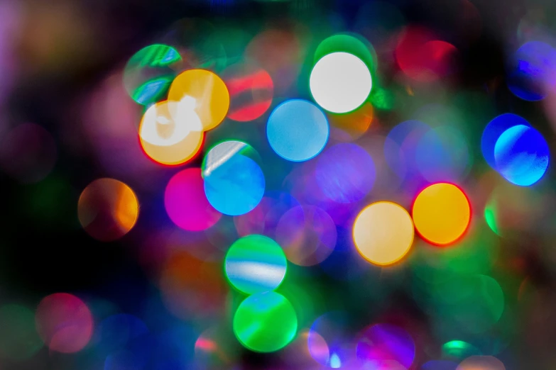 colored blurred christmas lights are seen in a close up