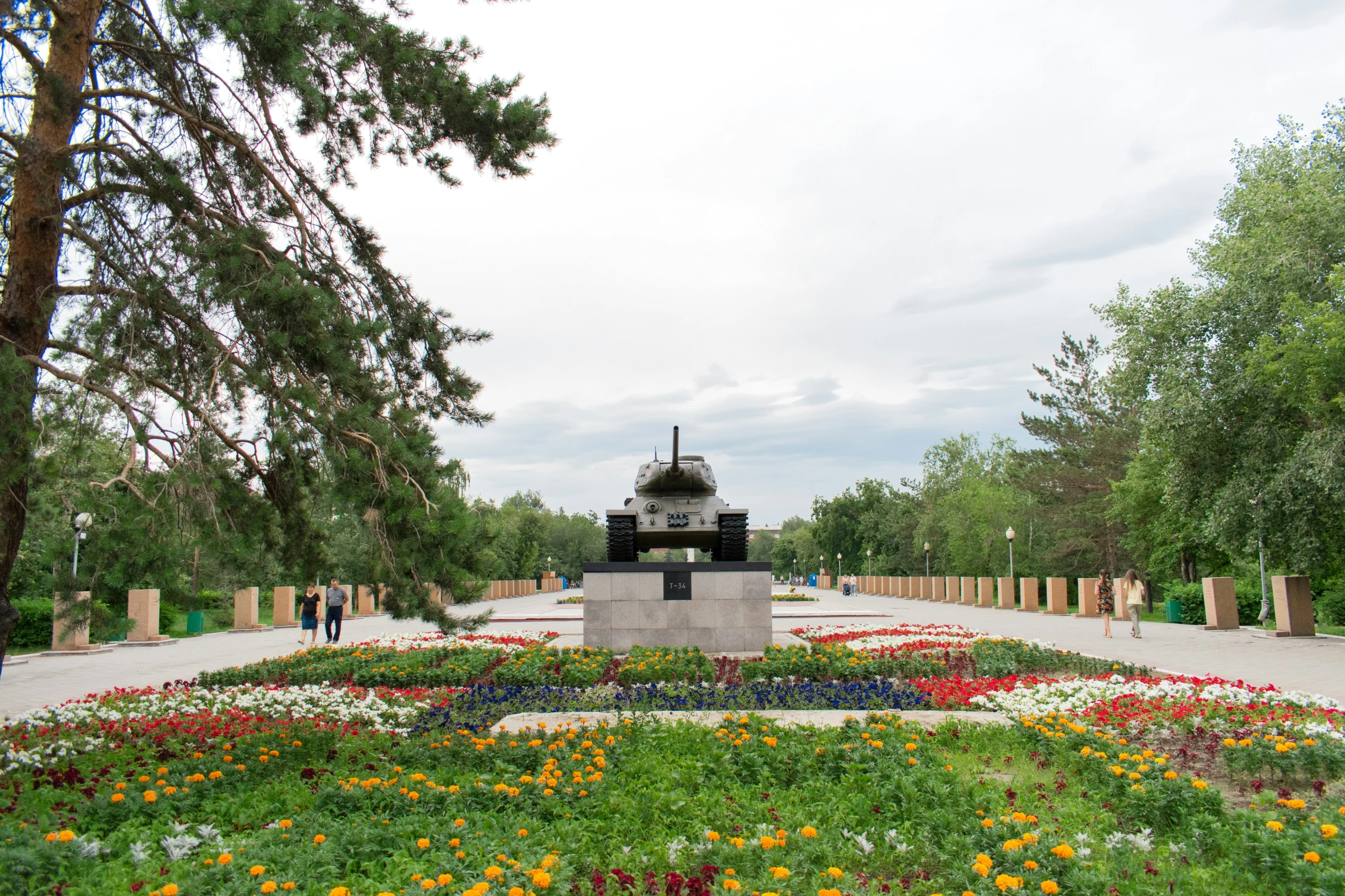 a landscape park with a clock and flowers