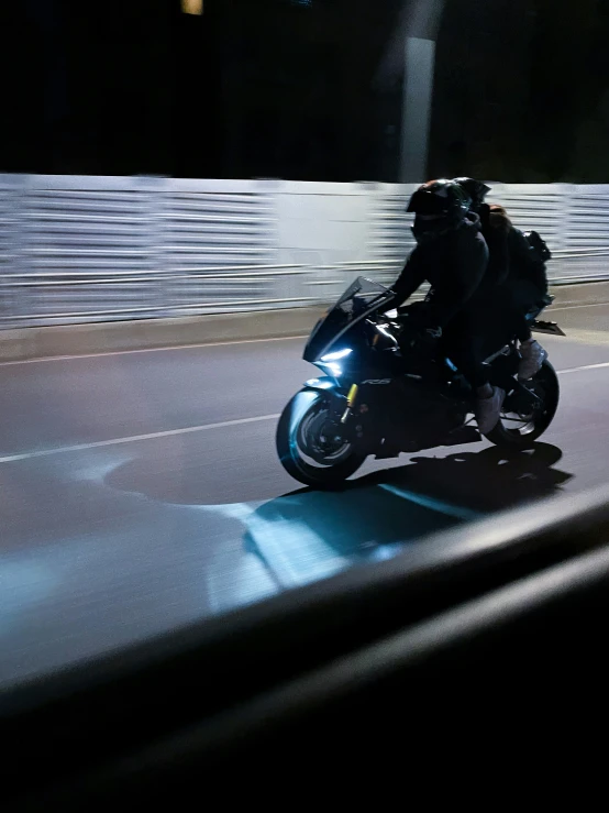 man riding his motorcycle at night on the road