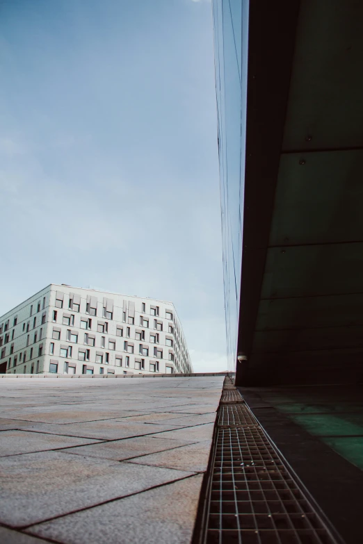 an open space with a very tall building in the background